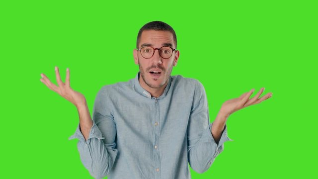 Puzzled young man on chroma screen with a gesture of confusion