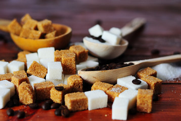 Grains of coffee and white and brown lump sugar