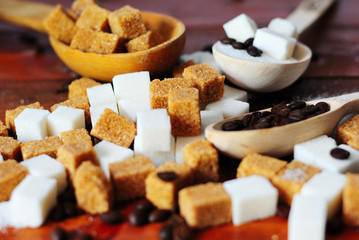 Grains of coffee and white and brown lump sugar