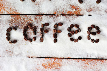 Coffee inscription from coffee grains on white scattered sugar