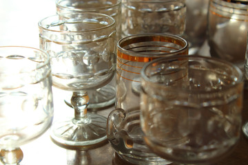 Old empty dusty glasses on the table. Close-up. Background.