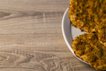 Lahmacun and organic vegetables on the wooden background for restaurant concept.