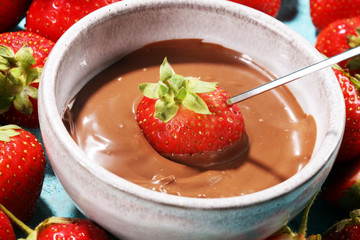 Fondue with Melting chocolate or melted chocolate and strawberry.