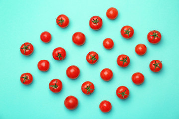 Flat lay composition with ripe tomatoes on color background