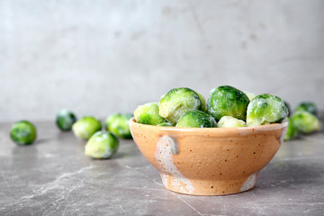 Bowl with frozen brussel sprouts on table. Vegetable preservation