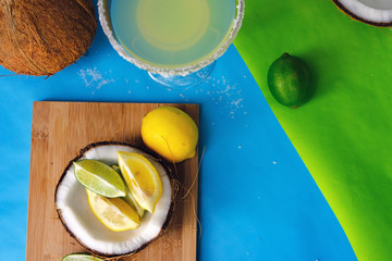 Vibrant and colorful food with margarita and fresh coconut holding fruit. 