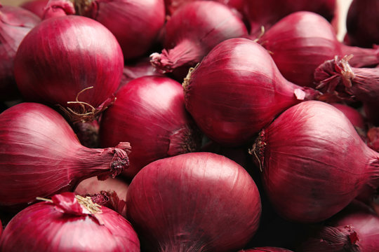 Ripe red onions as background