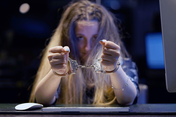Arrested woman handcuffed hands. Close-up of office worker, Prisoner or arrested terrorist, hacker,...