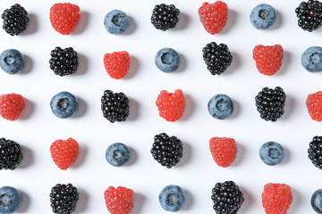 Composition with raspberries, blackberries and blueberries on white background