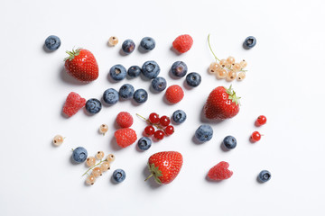 Raspberries and different berries on white background