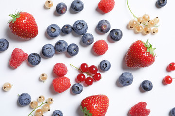 Obraz na płótnie Canvas Raspberries and different berries on white background