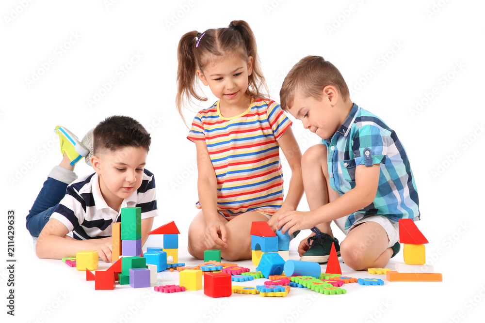 Wall mural little children playing together on white background. indoor entertainment