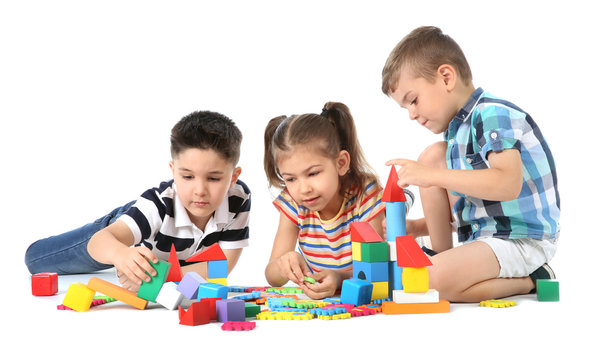Little children playing together on white background. Indoor entertainment