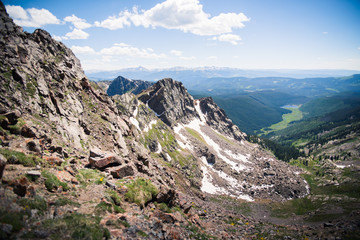 Landscape view overlooking Piney Lake and the Rocky Mountains from the summit of the Gore Range, 