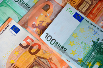 Paper banknotes of Euro 50 and 100. Cash close-up, color background of money view from above.