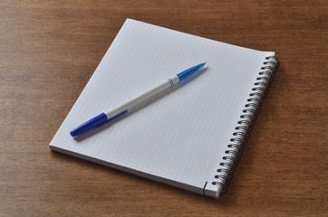 notebook on the desk with a pen for writing