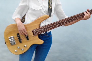 Girl holding a bass guitar