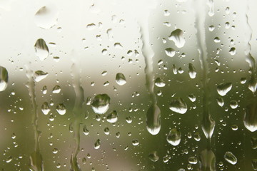 Wet, clear glass after the rain. Rain drops on the glass. Close-up. Background. Texture.