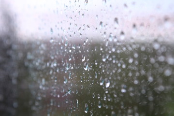 Wet, clear glass after the rain. Rain drops on the glass. Close-up. Background. Texture.