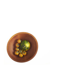 Orange Thai eggplants with green and yellow Summer Squash in wooden bowl isolated on white background with room for copy