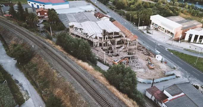 BUILDING IN RUINS BETWEEN TRAIN RAIL AND ROAD