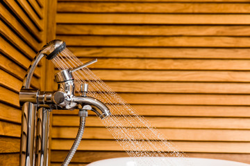 Bathroom with bath, shower and wooden backgrounds