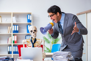 Angry boss yelling at his skeleton employee