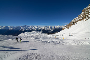 Naklejka premium MADONNA DI CAMPIGLIO, ITALY-21 November 2014:Beautiful winter mountains landscape Ski lift Ski resort in italy, The ski slope and skiers at Passo Groste ski area