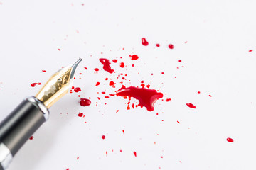 Fountain pen and fountain pen ink making a spatter on white paper