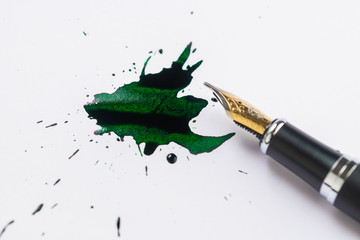Fountain pen and fountain pen ink making a spatter on white paper