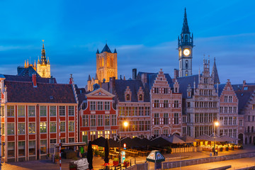 Fototapeta na wymiar Aerial view of picturesque medieval buildings on the quay Graslei and towers of Old Town during morning blue hour, Ghent, Belgium