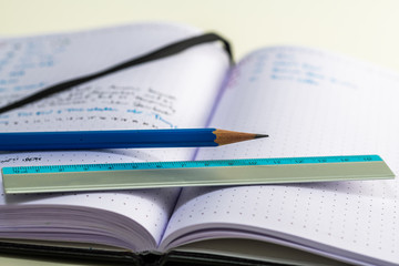 Notebook with writing, ruler, pencil, fountain pen