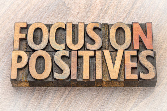 focus on positives - word abstract in wood type
