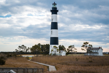The Bodie Island Lighthouse on the outer banks of North Carolina against a dramatic cloudy sky