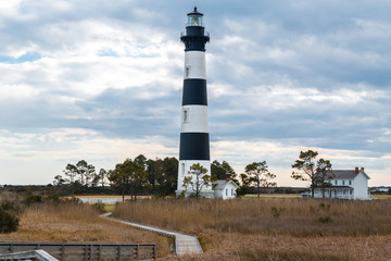 The Bodie Island Lighthouse on the outer banks of North Carolina against a dramatic cloudy sky