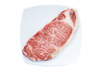 raw wagyu sirloin with plate isolated on white background. japanese beef