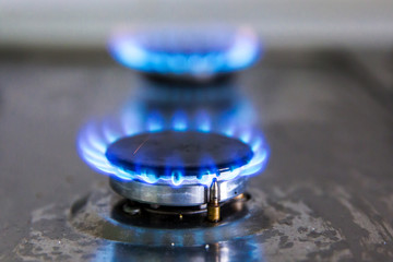Gas hobs on the stove. Burning blue gas. Gas burners
