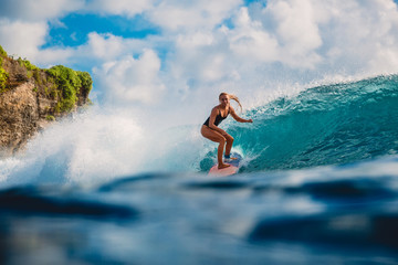 Surf girl on surfboard. Woman in ocean during surfing. Surfer and ocean wave