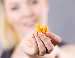 Woman holding protective earplugs