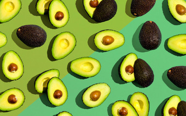 Fresh avocado pattern on a green background flat lay