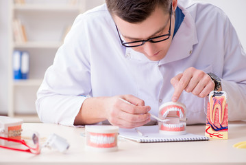 Dentist working teeth implant in medical lab