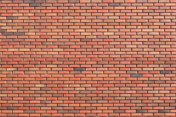 wall of colored bricks with different step of laying