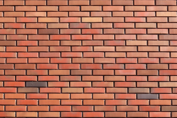 wall of colored bricks with different step of laying