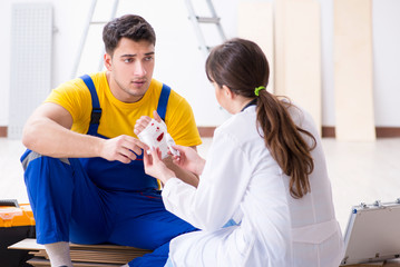 Injured worker being assisted by doctor