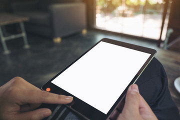 Mockup image of hands holding , touching and pointing at a black tablet pc with blank white desktop screen