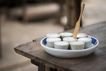 Thai Coconut Milk Custard in small porcelain cup - Khanom Thuai (Thai dessert). 