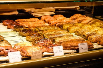 Bakery window in Paris showing delicious confectionery and their prices