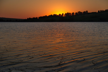 Fototapeta na wymiar Russia. Siberia, Altai Krai. Summer sunset on the overgrown lake