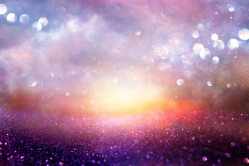 glitter vintage lights background. pink, blue, black and purple. de-focused.