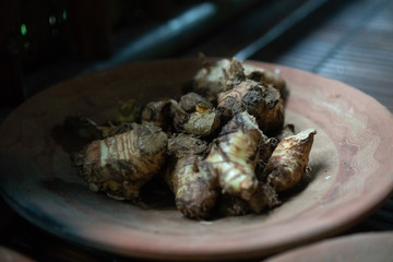 Closeup dried ginger on the rustic clay brown plate